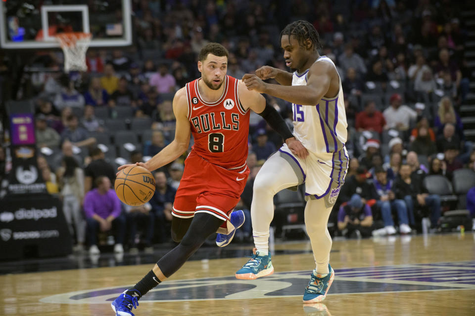 Chicago Bulls guard Zach LaVine (8) is guarded by Sacramento Kings guard Davion Mitchell (15) during the first quarter of an NBA basketball game in Sacramento, Calif., Sunday, Dec. 4, 2022. (AP Photo/Randall Benton)