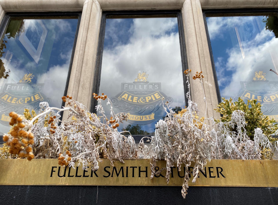 Dried out plants are seen in a window box outside the Butchers Hook & Cleaver pub, owned by Fuller?s, in London, Britain, July 3, 2020.   REUTERS/Simon Newman