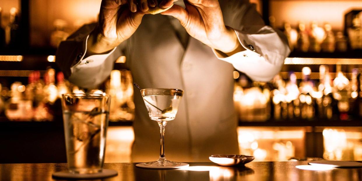 bartender finishing a martini cocktail