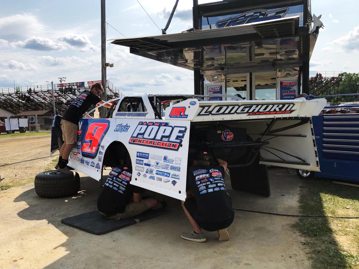 Crew members prepare Devin Moran's No. 9 late model for the Prime 50 Lucas Oil Late Model Dirt Series race in 2021 at the Muskingum County Speedway. The speedway will hold its 2024 opening night on Saturday, April 27.