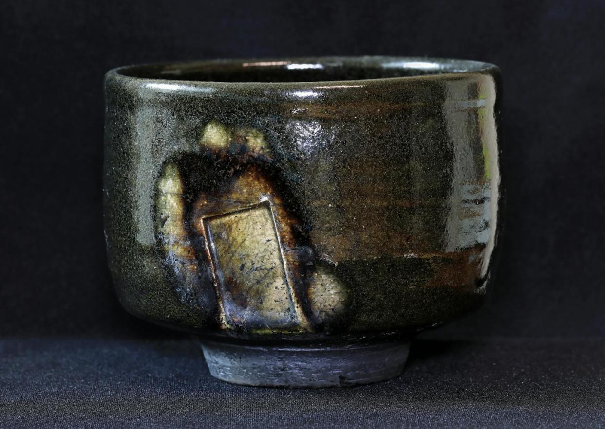 A perfectly imperfect tea bowl. <a href="https://www.gettyimages.com/detail/photo/earthenware-bowl-with-glazing-against-black-royalty-free-image/1689830483?phrase=wabi+sabi&adppopup=true" rel="nofollow noopener" target="_blank" data-ylk="slk:Zen Rial/Moment via Getty Images;elm:context_link;itc:0;sec:content-canvas" class="link ">Zen Rial/Moment via Getty Images</a>