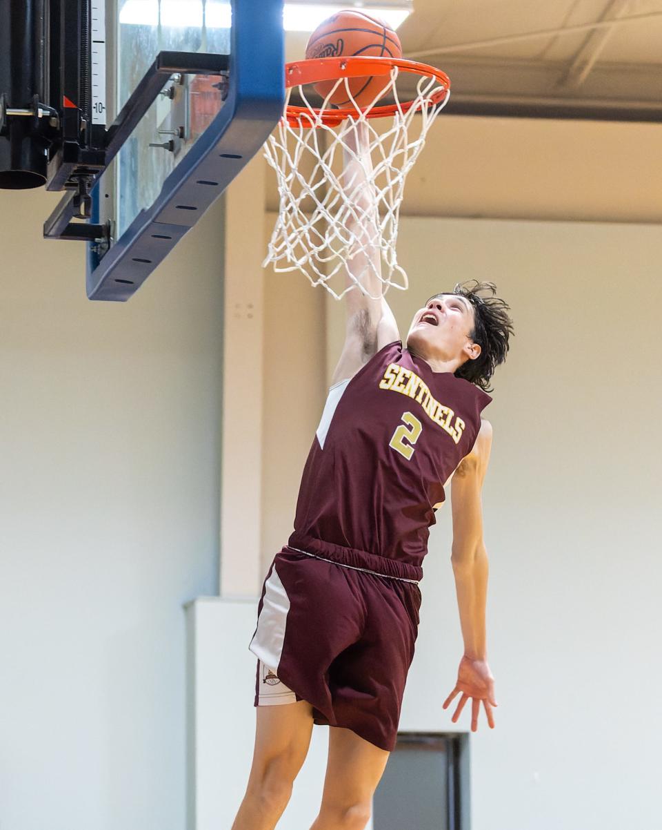 Andrej Spirko dunks the basketball after blocking a shot, giving Charyl Stockwell a four-point lead in overtime on its way to a 59-52 victory at Livingston Christian on Tuesday, Feb. 1, 2022.