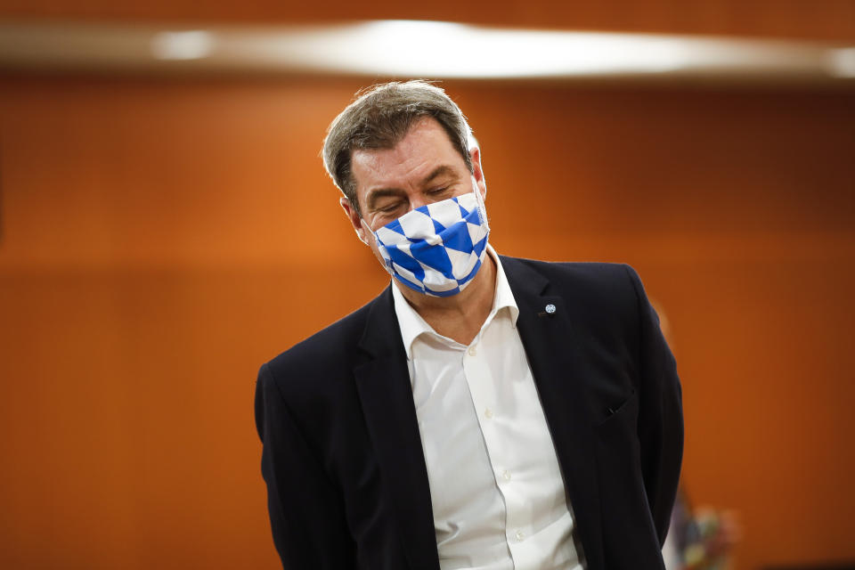 File - In this Wednesday, June 17, 2020 file photo Bavarian Prime Minister Markus Soeder of the Christian Social Union, CSU, party, wears a face mask with Bavarian's white and blue diamond pattern as he arrives for a meeting with German Chancellor Angela Merkel and German federal states governors at the chancellery in Berlin, Germany. German Chancellor Angela Merkel's center-right party, the Christian Democratic Union, CDU, is choosing a new leader on the weekend Saturday Jan. 16 and Sunday Jan. 17, 2021, a decision that will help determine who succeeds Merkel at the helm of the European Union's biggest economy after a 16-year reign. (AP Photo/Markus Schreiber, Pool, file)