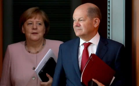 German Chancellor Angela Merkel (left) and Finance Minister Olaf Scholz - Credit: &nbsp;Michael Sohn/AP