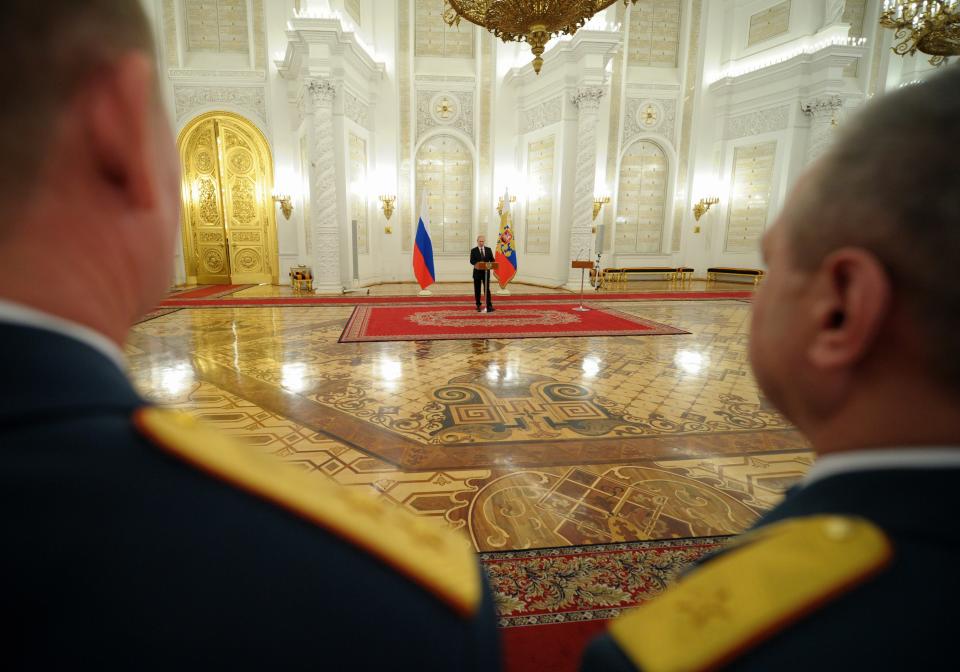 Russian President Vladimir Putin speaks at the presentation ceremony of the top military brass in the Kremlin in Moscow, Russia, Friday, March 28, 2014. Russia's president says Ukraine could regain some arms and equipment of military units in Crimea that did not switch their loyalty to Russia. (AP Photo/RIA-Novosti, Alexei Druzhinin, Presidential Press Service)