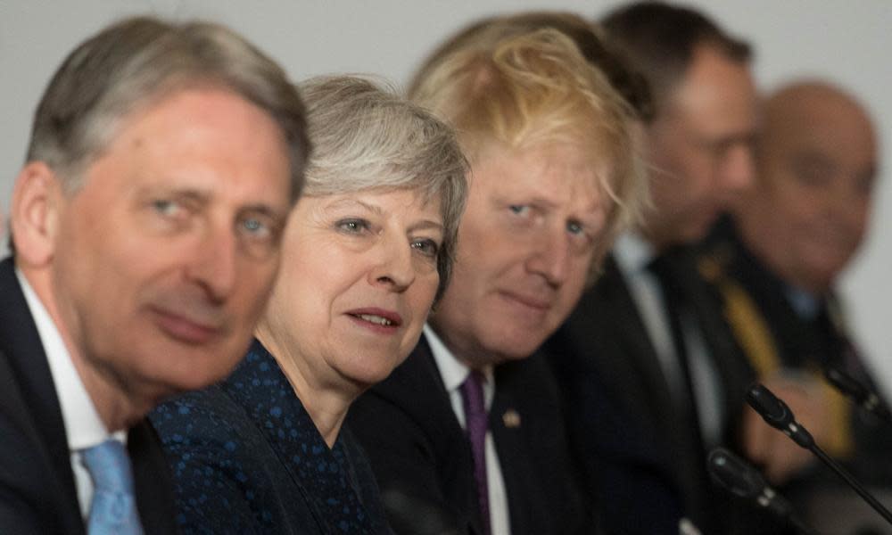  Philip Hammond, Theresa May and Boris Johnson look up during UK-France summit in Sandhurst.