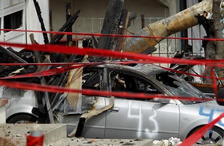 A damage automobile is seen in a neighborhood that was destroyed when a natural gas pipeline ruptured and exploded, killing four people, and created a firestorm that destroyed 37 homes and injured more than 50 people last Thursday, in San Bruno, California September 13, 2010. REUTERS/Robert Galbraith
