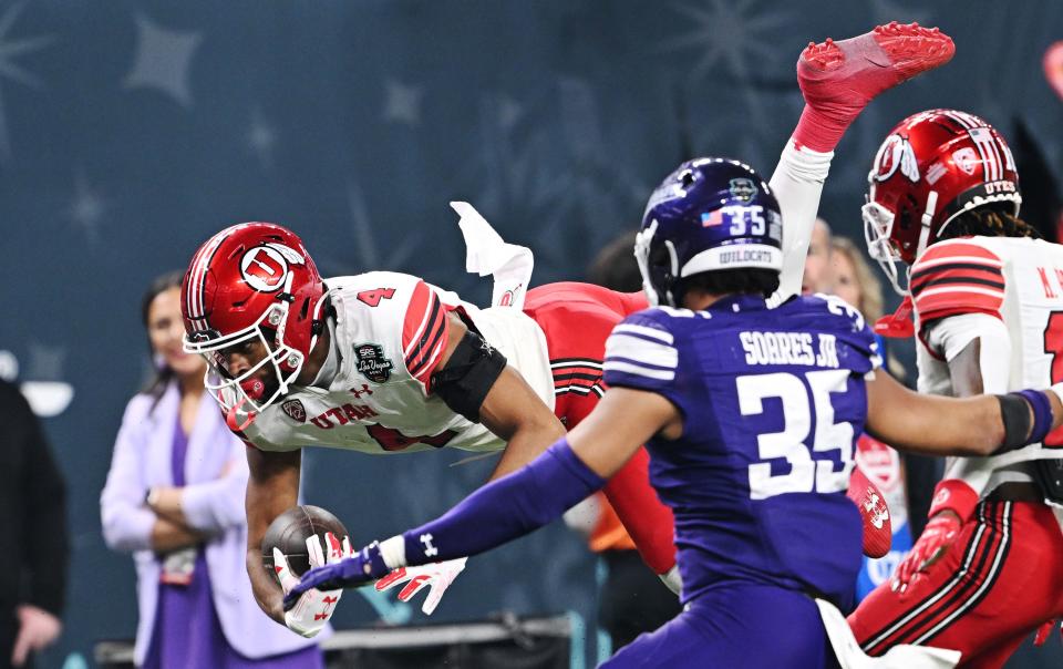 Utah Utes wide receiver Munir McClain (4) falls after being hit as Utah and Northwestern play in the SRS Distribution Las Vegas Bowl at Allegiant Stadium on Saturday, Dec. 23, 2023. Northwestern won 14-7. | Scott G Winterton, Deseret News