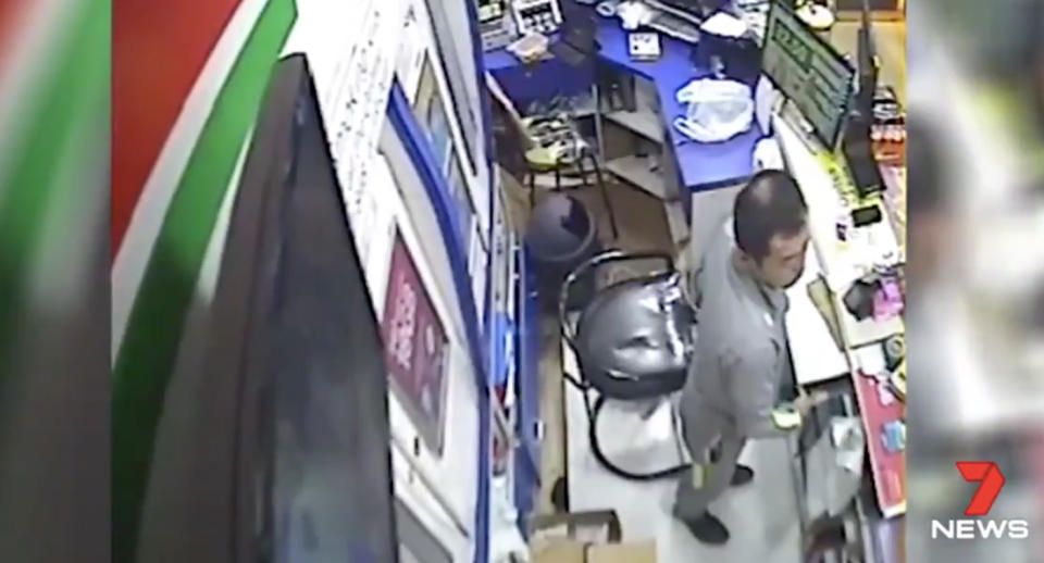 Security pictures show a man wandered behind the counter and took the till. Source: 7 News
