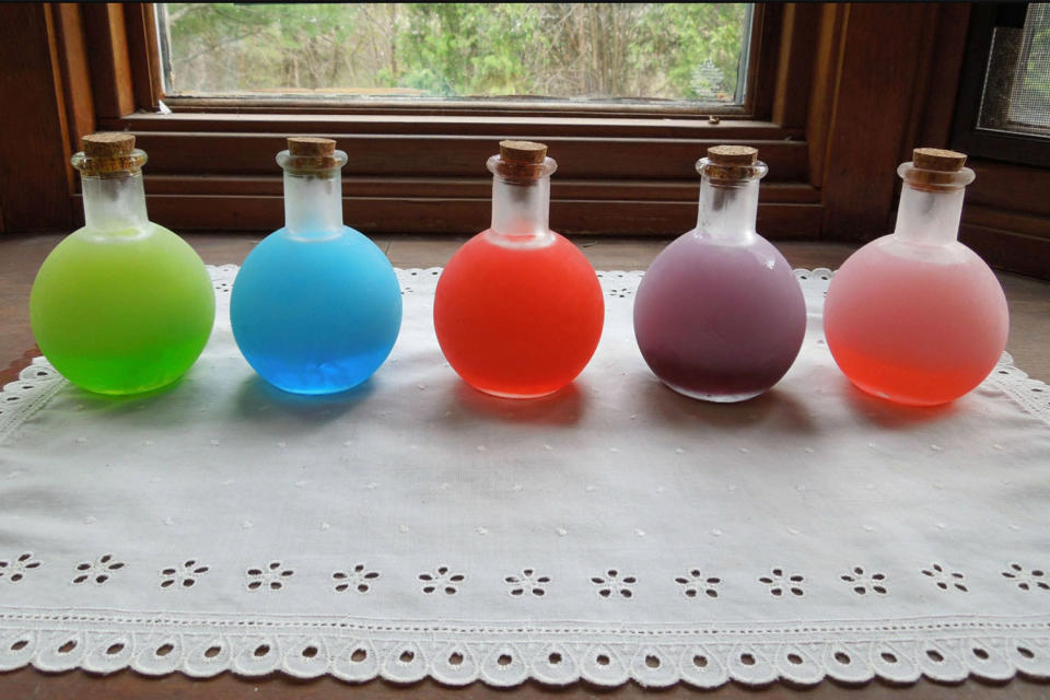 Different pitchers of colored vodka.