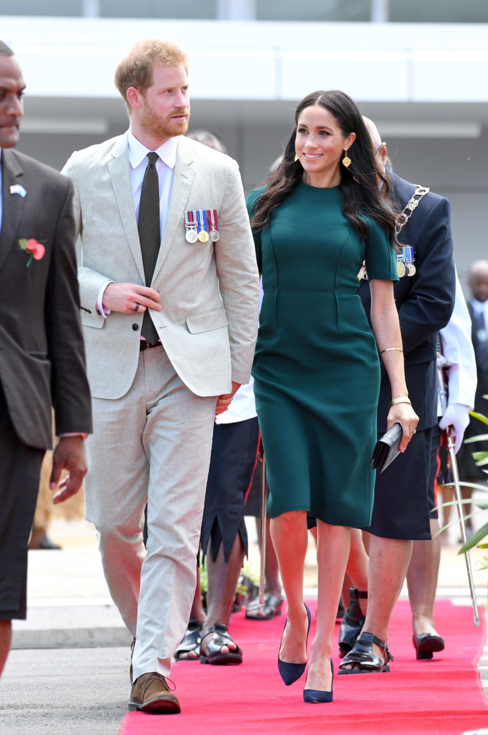 Looking at snaps from Harry and Meghan’s royal tour, it’s become evident than the Duchess of Sussex always walks one step behind her husband. Photo: Getty Images