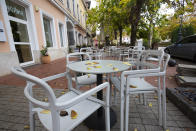 FILE - In this Nov. 11, 2020, file photo, empty seats are seen at a restaurant's terrace in Nagykanizsa, Hungary. The European Union still hasn't completely sorted out its messy post-divorce relationship with Britain — but it has already been plunged into another major crisis. This time the 27-member union is being tested as Poland and Hungary block passage of its budget for the next seven years and an ambitious package aimed at rescuing economies ravaged by the coronavirus pandemic. (Gyorgy Varga/MTI via AP, File)