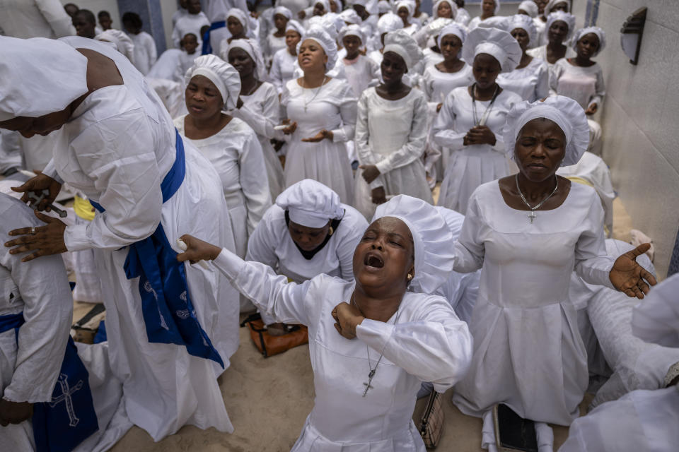 Members of the congregation sing and chant during a church service in which they prayed for the country ahead of elections and against the forces of evil, at the Celestial Church of Christ Olowu Cathedral on Lagos Island in Nigeria Friday, Feb. 24, 2023. Nigerian voters are heading to the polls Saturday to select a new president following the second and final term of incumbent President Muhammadu Buhari. (AP Photo/Ben Curtis)