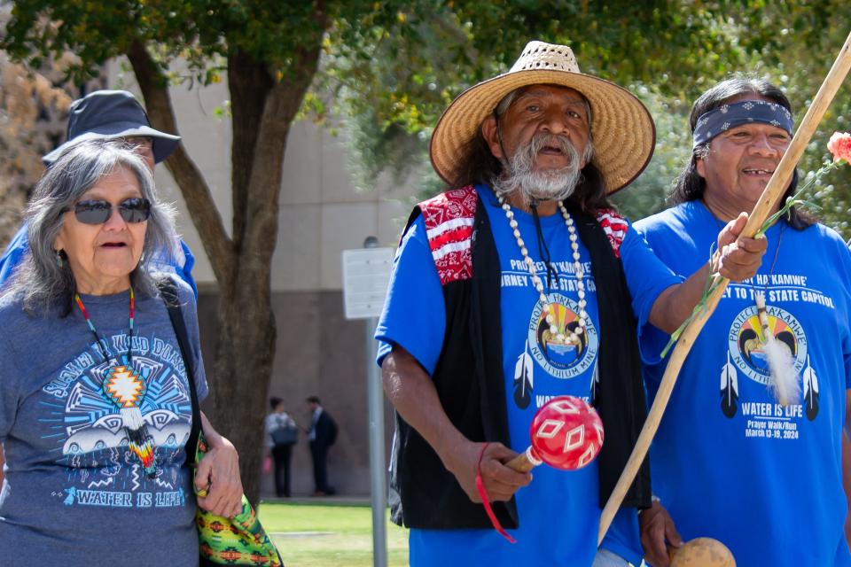 Mona Polacca, Ivan Bender and Frank Mapatis march outside the Arizona State Capitol chanting "Protect Ha'Kamwe'," on March 19, 2024.