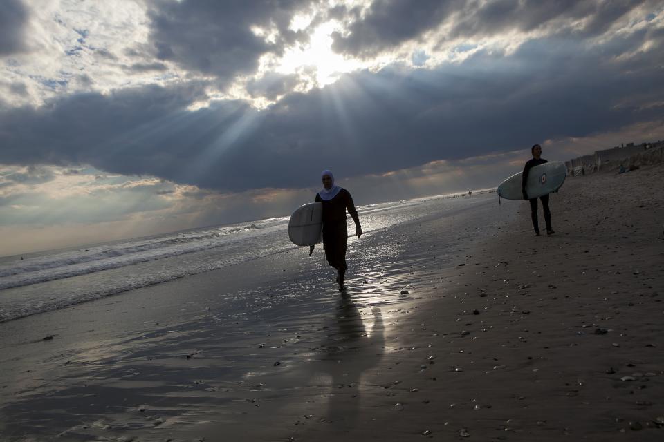 Participants walk along the beach after the third annual Rockaway Halloween surf competition at Rockaway Beach in the Queens borough of New York