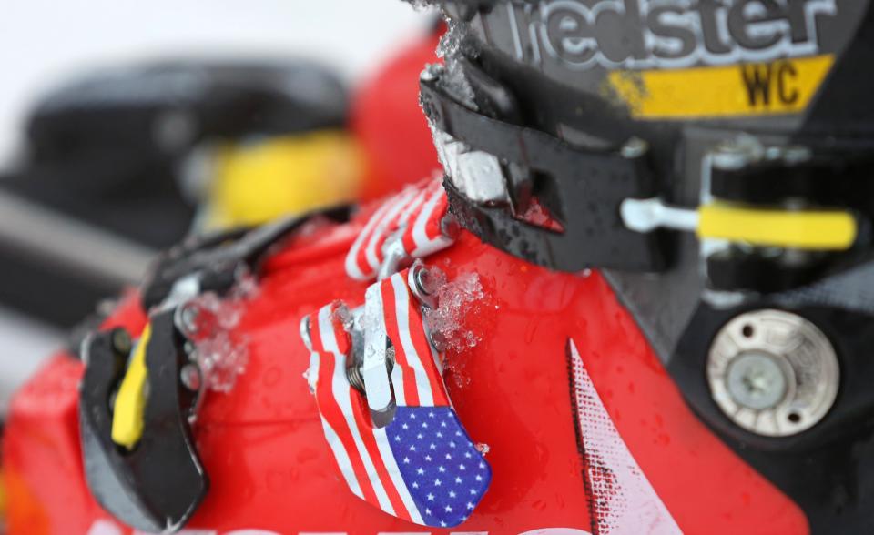 A close-up of the ski boot clip of United States' Mikaela Shiffrin as she stands on the alpine skiing training slopes at the Sochi 2014 Winter Olympics, Monday, Feb. 17, 2014, in Krasnaya Polyana, Russia. (AP Photo/Alessandro Trovati)