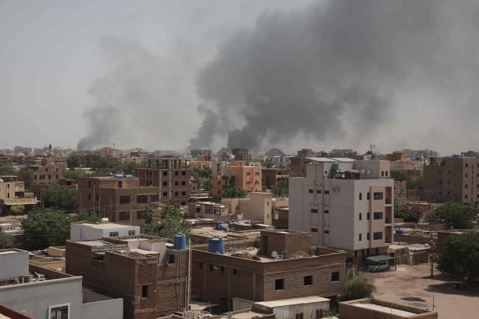 Smoke rises from a central neighborhood of Khartoum, Sudan, Sunday, April 16, 2023, after dozens have been killed in two days of intense fighting. The Sudanese military and a powerful paramilitary group are battling for control of the chaos-stricken nation for a second day.(AP Photo/Marwan Ali)