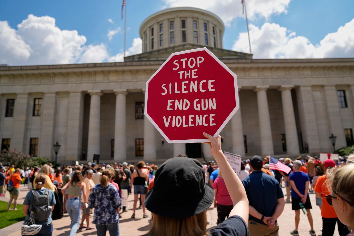 While attending with several Ohio State student friends, Lauren Branch, 22, of Mansfield, holds up a sign during the March For Our Lives rally against gun violence Saturday, June 11, 2022, at the Ohio Statehouse in Columbus. Hundreds gathered outside the Statehouse to protest recent mass shootings and encourage lawmakers to pass gun control legislation. The rally was just one of numerous gatherings Saturday across the country.