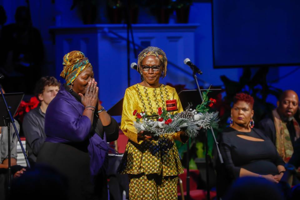 Patt Gunn and Rosalyn Rouse honor the slaves buried in unmarked graves in and around the former Calhoun Square before the Theater of War production of Antigone on Wednesday December 21, 2022 at First African Baptist Church.