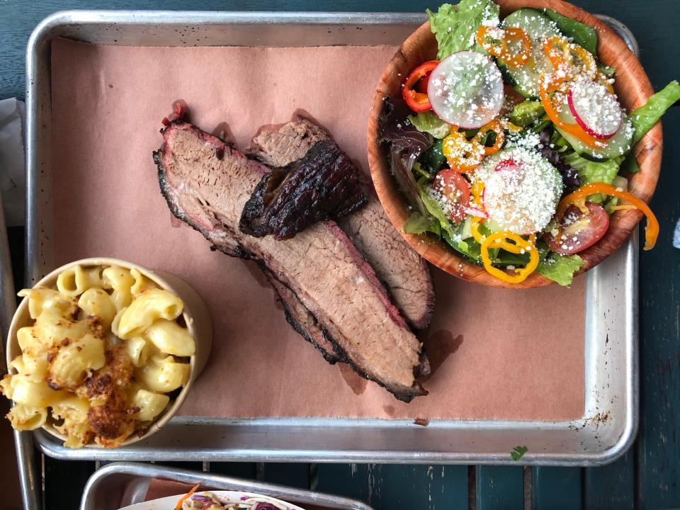 A brisket meat and three meal ($18) at Industry Beer and Barbecue in Naples is served with two sides, house-made pineapple slaw, house pickles and garlic "buttah" toast.