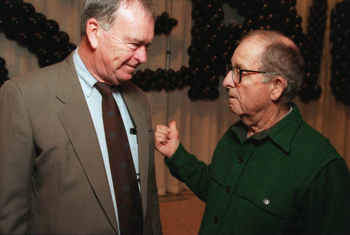 Frank A. Daniels Jr. discusses retirement with former Managing Editor Woodrow Price of The News & Observer at a gathering in 1996.