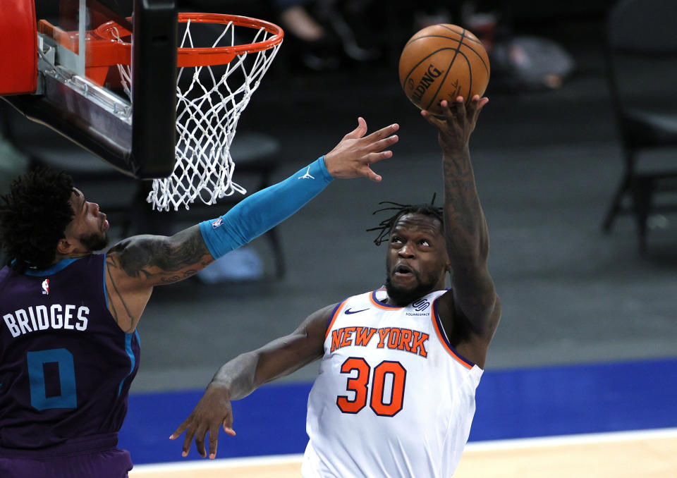 New York Knicks' Julius Randle goes to the basket as Charlotte Hornets' Miles Bridges defends during the second half of an NBA basketball game Tuesday, April 20, 2021, in New York. (Sarah Stier/Pool Photo via AP)