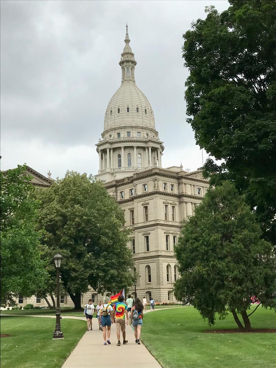 People head to the Michigan State Capitol building before the 2022 Michigan Pride Rally on June 26, 2022.