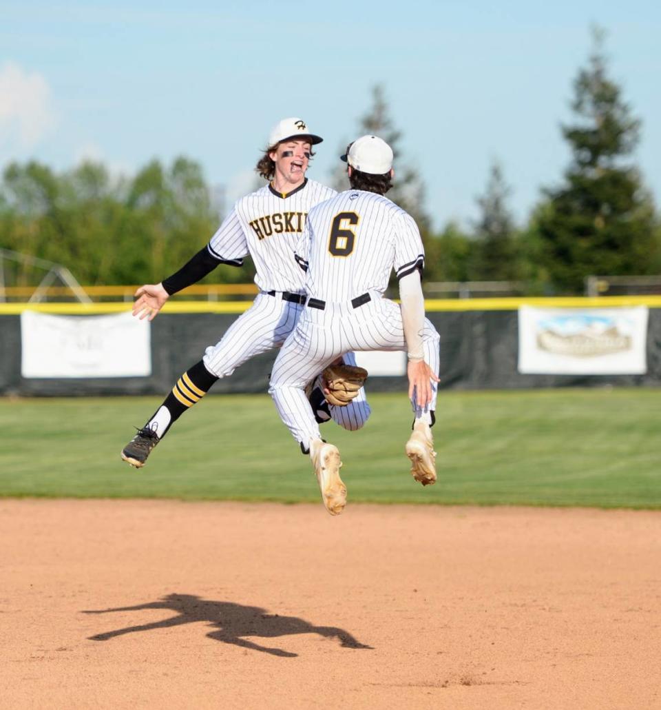 Hughson infielders Caleb Wilson and Beau Blake celebrate a 5-0 win after a Trans Valley League game against Ripon at Ripon High School in Ripon, Calif. on April 18, 2024.