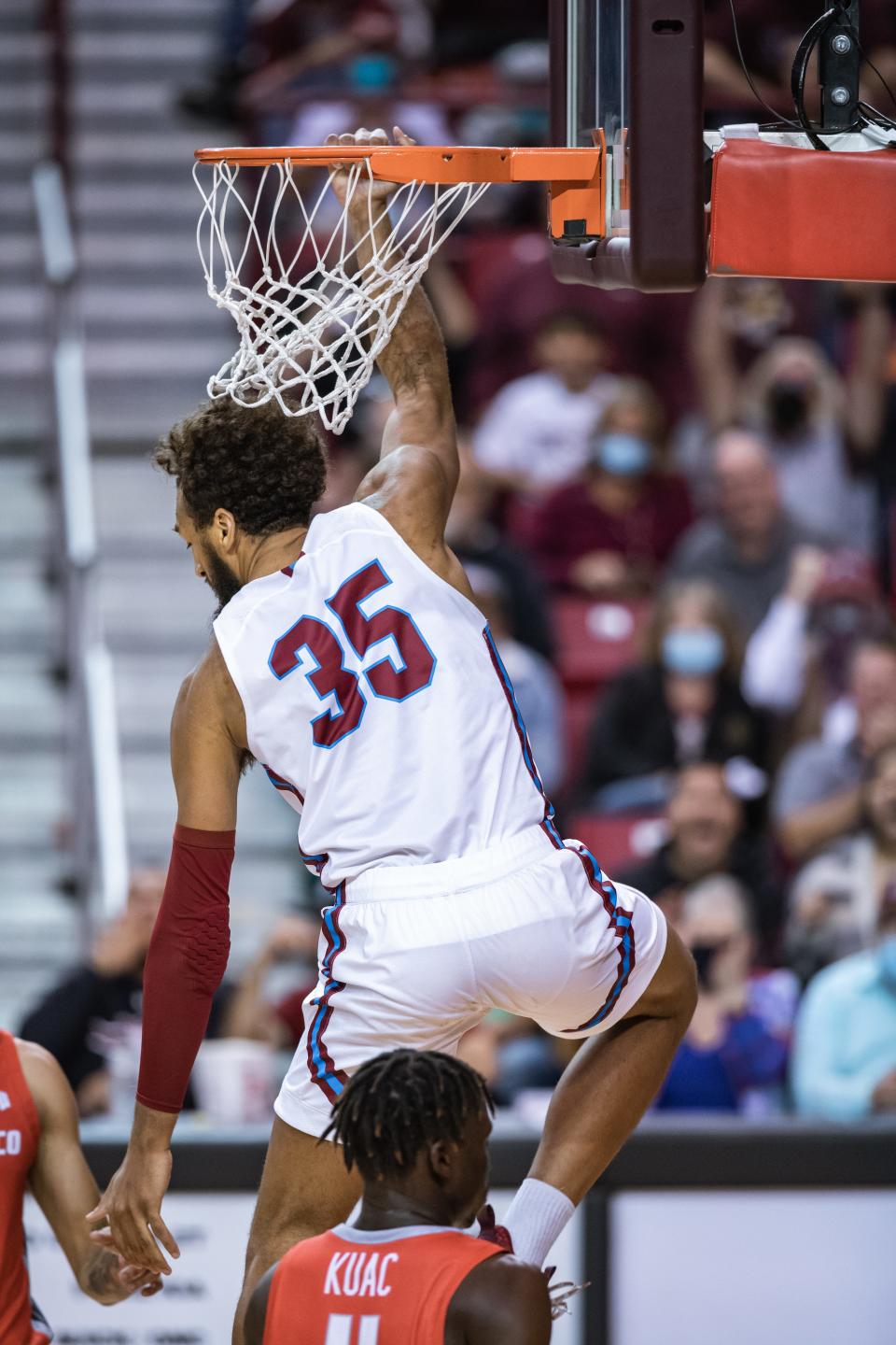 Johnny McCants (35) dunks as the New Mexico State Aggies face off against the University of New Mexico Lobos at the Pan American Center in Las Cruces on Tuesday, Nov. 30, 2021.