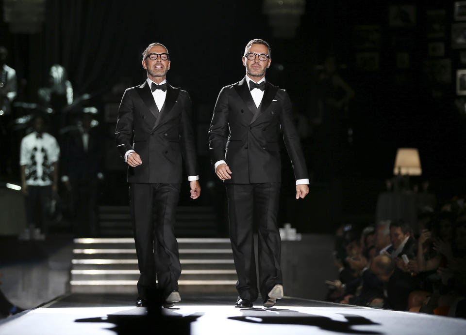 Canadian designers Dean and Dan Caten take the catwalk at the end of their DSquared2 men's Fall-Winter 2013-14 collection, part of the Milan Fashion Week, unveiled in Milan, Italy, Tuesday, Jan. 15, 2013. (AP Photo/Antonio Calanni)