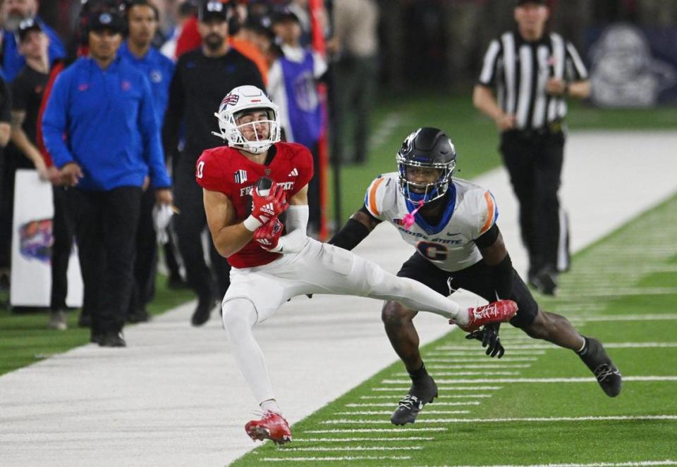 Fresno State’s Mac Dalena, left, makes the catch with Boise State’s Jaylen Clark to the right, Saturday, Nov. 4, 2023 in Fresno. Fresno State led 20-10 at halftime.