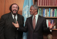 FILE - In this file photo dated Thursday, Oct. 9, 1997, Opera great Luciano Pavarotti, left, pays a courtesy visit to Kofi Annan, Secretary General of the United Nations, at the United Nations. Photographers asked Pavarotti and Annan for a duet and they reacted in jest. Annan, one of the world's most celebrated diplomats and a charismatic symbol of the United Nations who rose through its ranks to become the first black African secretary-general, has died aged 80, according to an announcement by his foundation Saturday Aug. 18, 2018.(AP Photo/Marty Lederhandler, FILE)