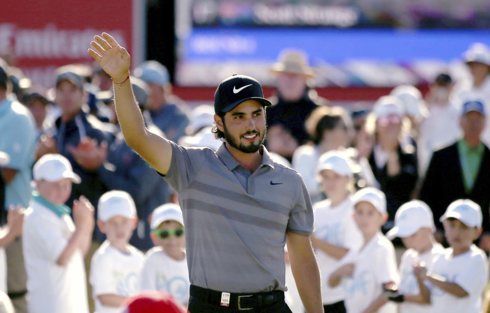 Abraham Ancer of Mexico waves after winning the Australian Open Golf tournament in Sydney, Sunday, Nov. 18, 2018. (AP Photo/Rick Rycroft)