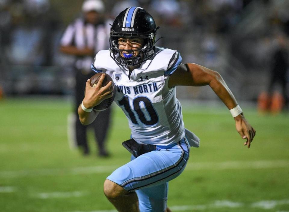Clovis North quarterback Mario Cosma scrambles out of the pocket on a keeper during their TRAC opener against Clovis East at Lamonica Stadium on Friday, Sept. 29, 2023. CRAIG KOHLRUSS/ckohlruss@fresnobee.com