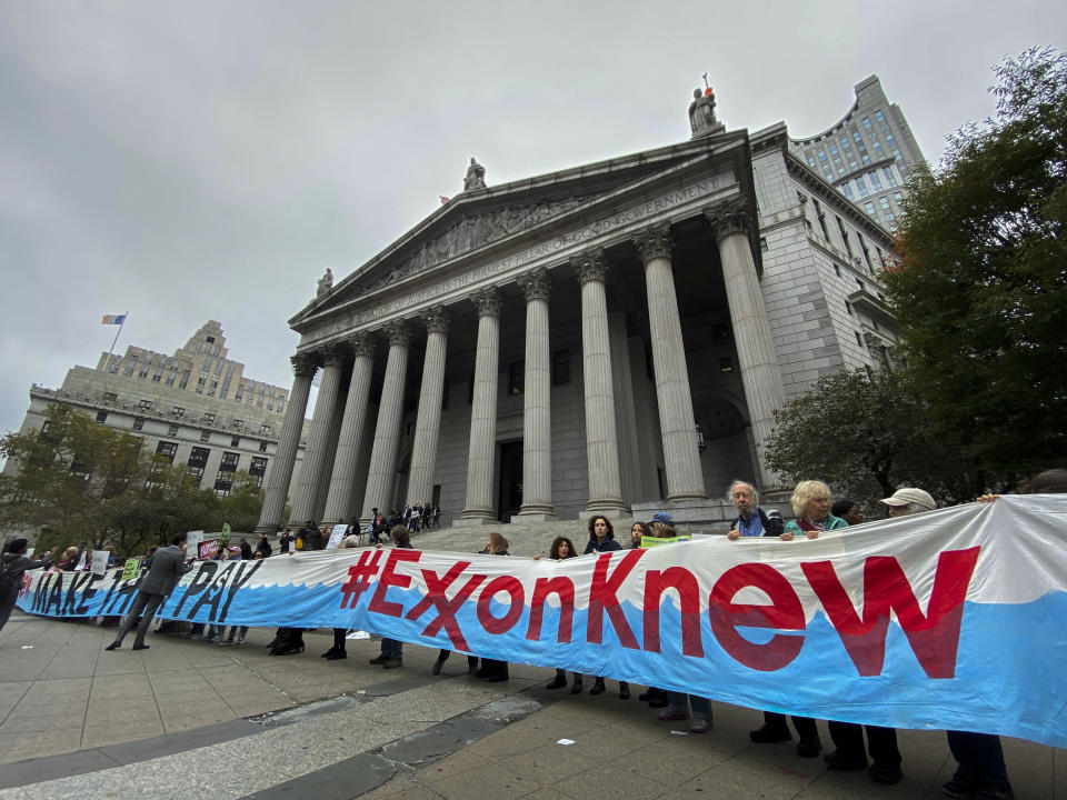 NEW YORK, USA - October 22: People take part in a protest against ExxonMobil before the start of its trial outside the New York State Supreme Court building on October 22, 2019 in New York, USA. the trial will establish whether Exxon Mobil, the country's largest fossil fuel company, lied to investors about the cost of carbon emissions to its business. (Photo by Eduardo MunozAlvarez/VIEWpress)