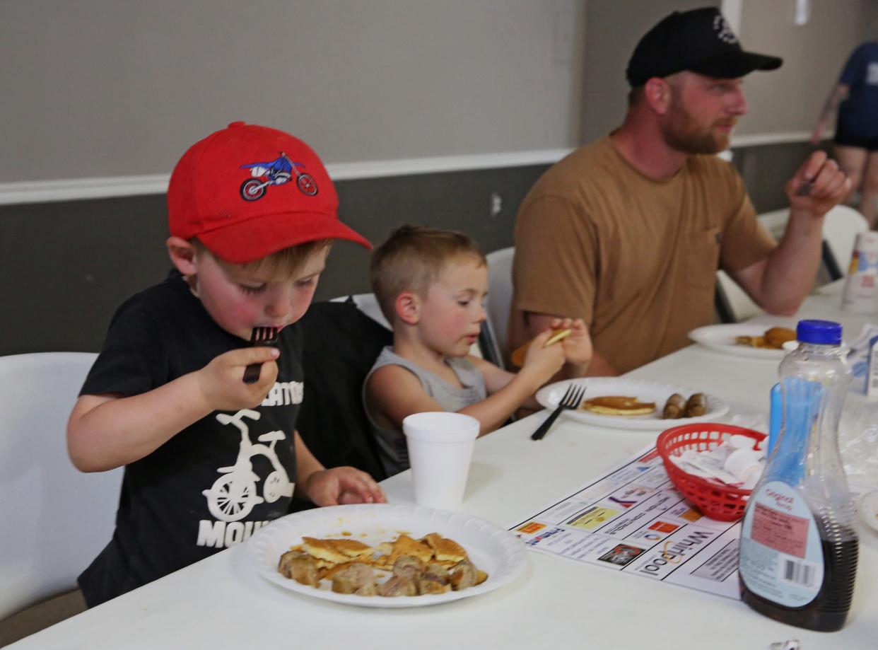 Leroy Spriggs, age 5 of Fremont, enjoys his pancakes and sausage, along with his cousin Fitz Vance, and his dad Joe Spriggs on April 17.