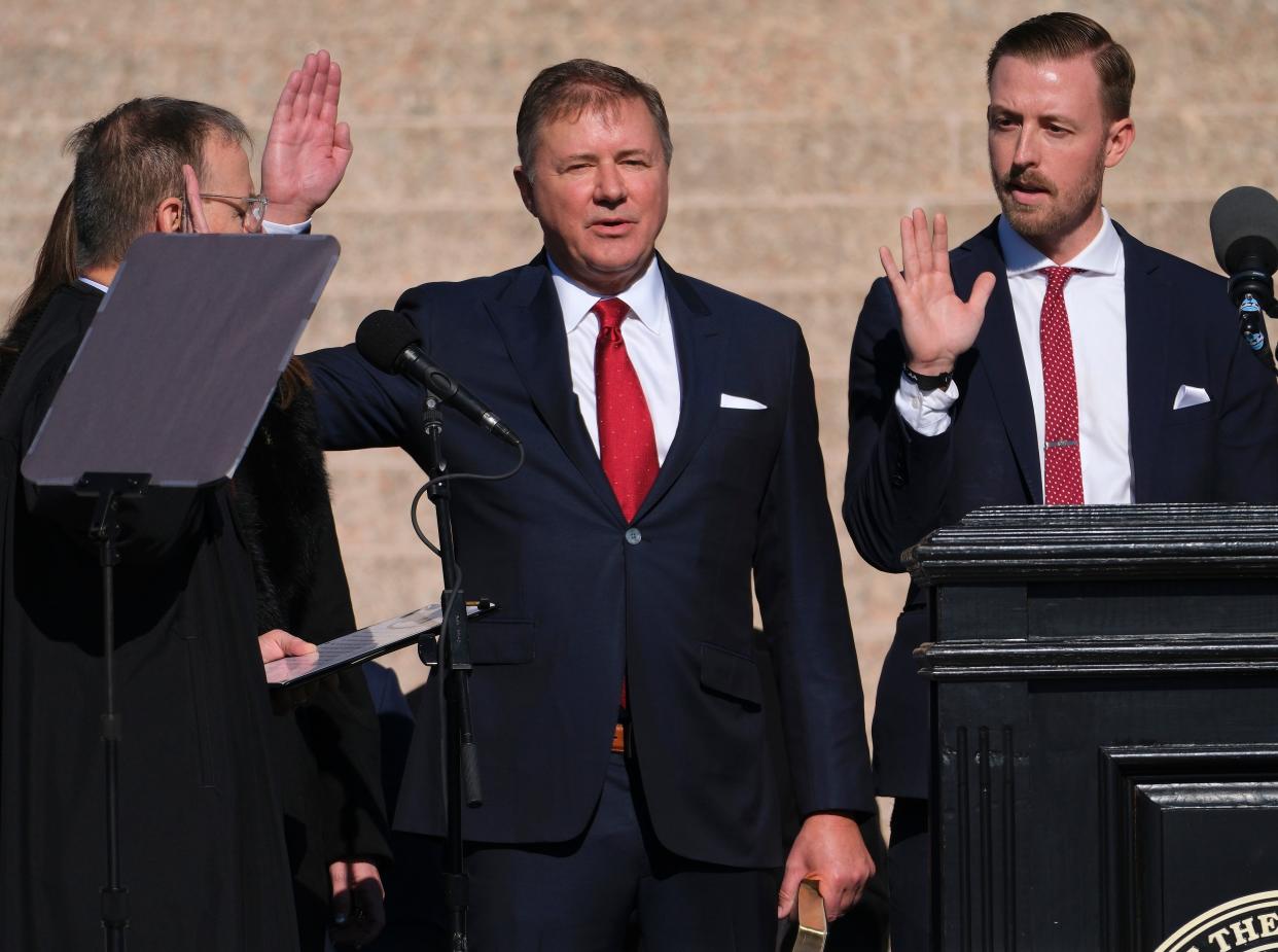 Attorney General Gentner Drummond, left, and state schools Superintendent Ryan Walters are administered the oath by Oklahoma Supreme Court Chief Justice M. John Kane IV during Inauguration Day ceremonies at the Oklahoma Capitol on Jan. 9, 2023.