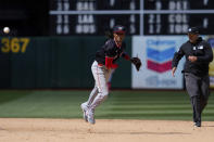 Washington Nationals shortstop CJ Abrams, center, turns a double play after forcing out Oakland Athletics' Lawrence Butler at second during the seventh inning of a baseball game, Sunday, April 14, 2024, in Oakland, Calif. Shea Langeliers was out at first on the play. (AP Photo/Godofredo A. Vásquez)