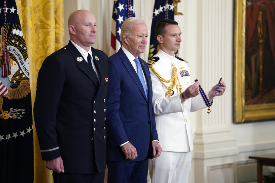 President Joe Biden listens before presenting the Medal of Valor, the nation's highest honor for bravery by a public safety officer, to Lt. Justin Hespeler, of the New York City Fire Dept., during an event in the East Room of the White House, Wednesday, May 17, 2023, in Washington. (AP Photo/Evan Vucci)