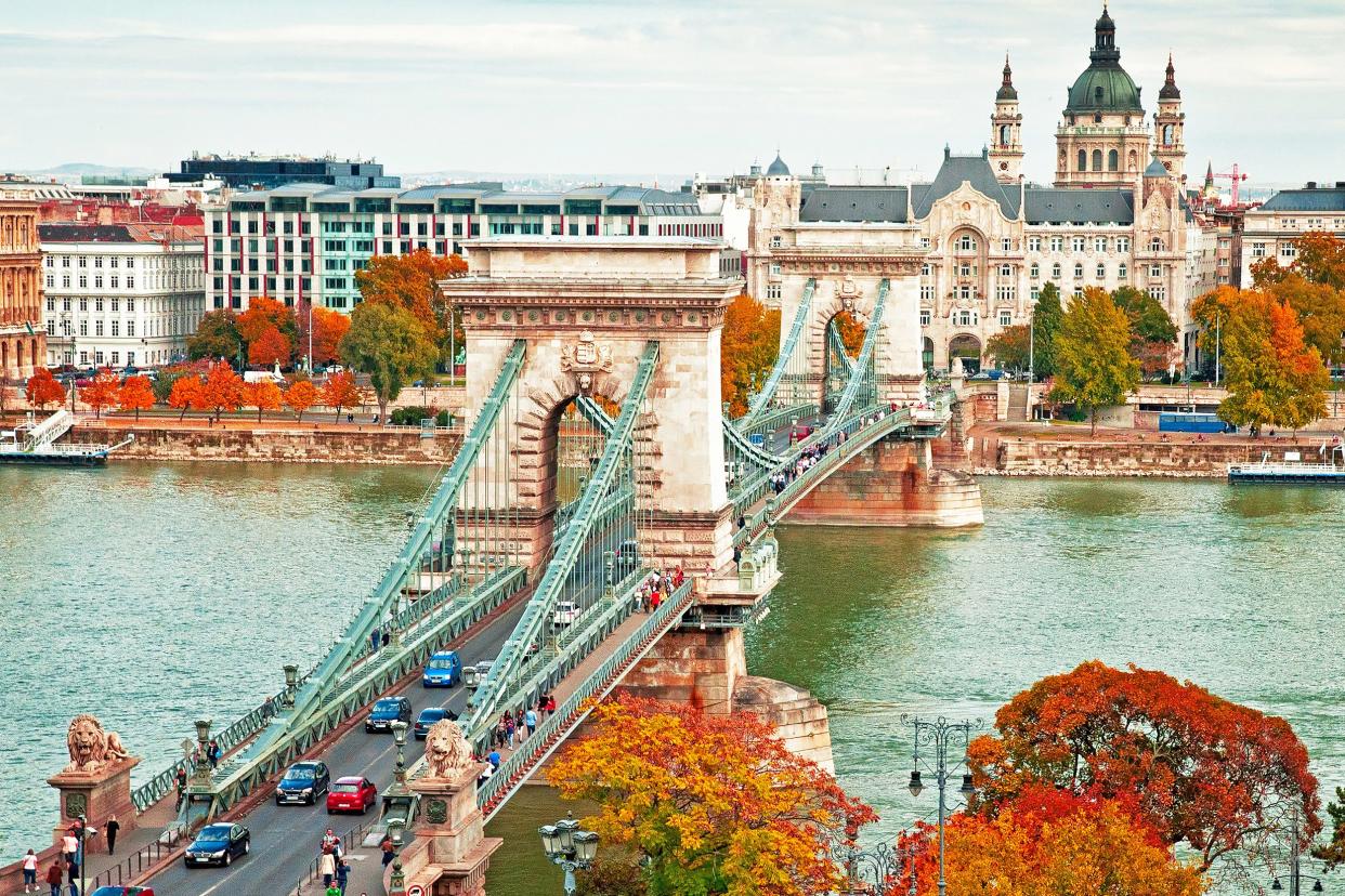 Famous Chain Bridge in Budapest, Hungary during autumn, surrounded by colorful trees