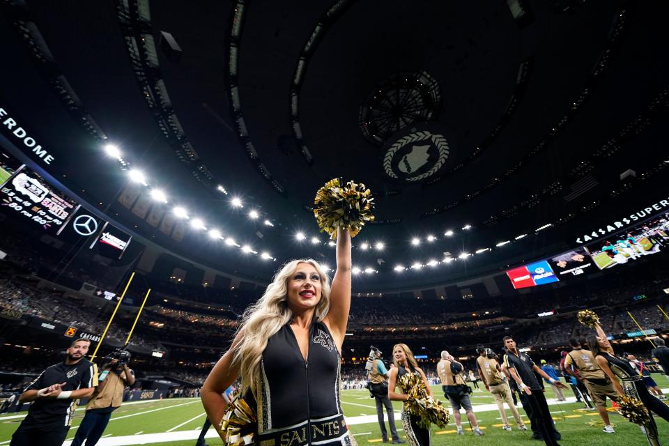 A New Orleans Saints cheerleader performs in the newly re-named Caesar's Superdome before an NFL preseason football game against the Jacksonville Jaguars in New Orleans, Monday, Aug. 23, 2021. (AP Photo/Gerald Herbert)