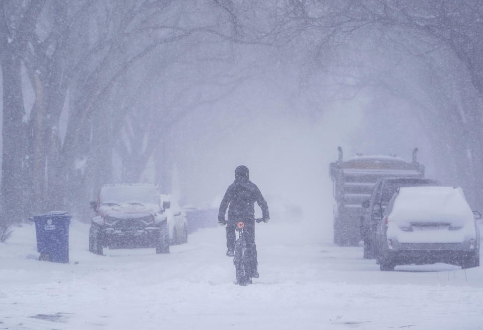 A person cycles on a street in Saskatoon, Saskatchewan, Monday, Feb. 26, 2024. (Heywood Yu/The Canadian Press via AP)