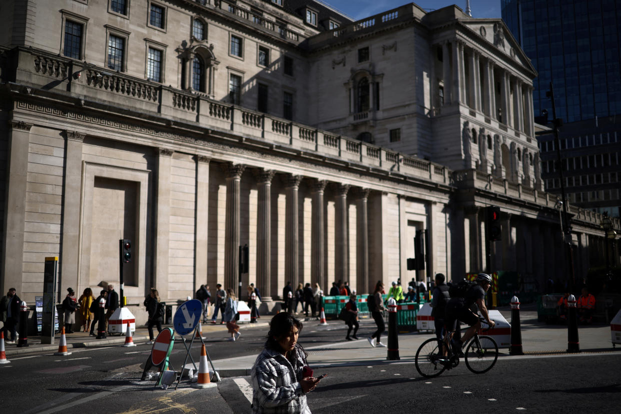 People walk outside the Bank of England in the City of London financial district in London, Britain May 11, 2023. REUTERS/Henry Nicholls