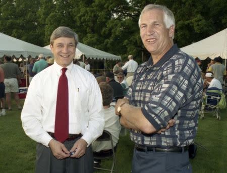 Penn State University President Graham Spanier (L) and Second Mile founder and Penn State assistant football coach Jerry Sandusky, attend the Second Mile Celebrity Golf Classic, in State College, Pennsylvania, in this 1997 file photo. REUTERS/Craig Houtz/Files