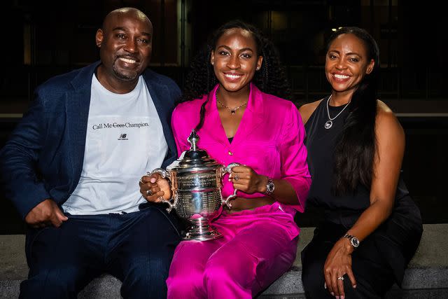 <p>Robert Prange/Getty</p> Coco Gauff of the United States with father Corey and mother Candi during the champions photo shoot on September 09, 2023 in New York City.
