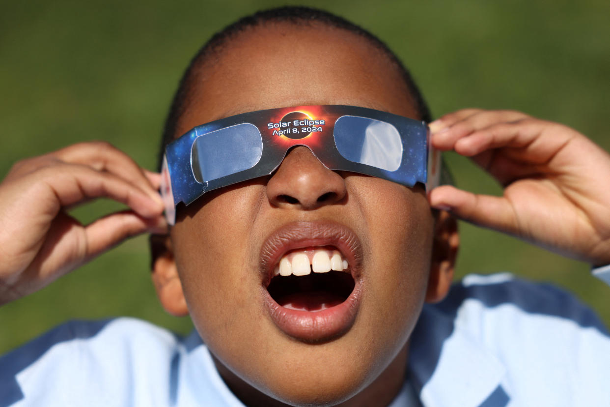 Adrian Plaza, 9, of Queens, tests his eclipse glasses ahead of a partial solar eclipse.
