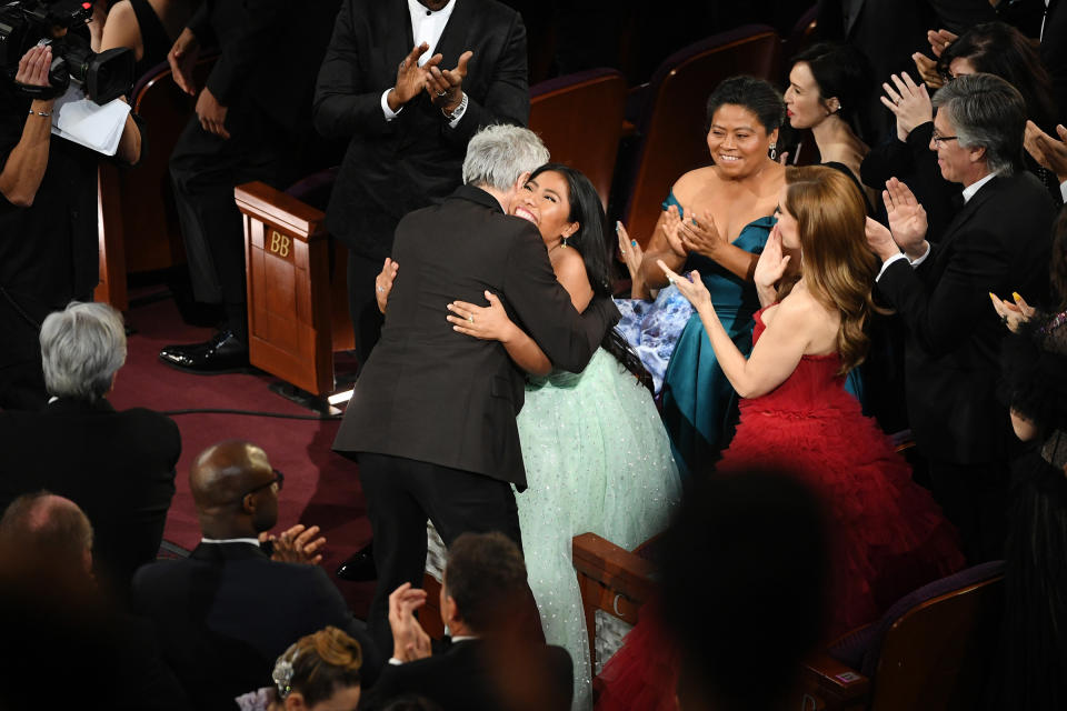 Yalitza Aparicio hugs Alfonso Cuaron after Cuaron won the Cinematography award for 'Roma' during the 91st Annual Academy Awards on Feb. 24, 2019. | Kevin Winter—Getty Images