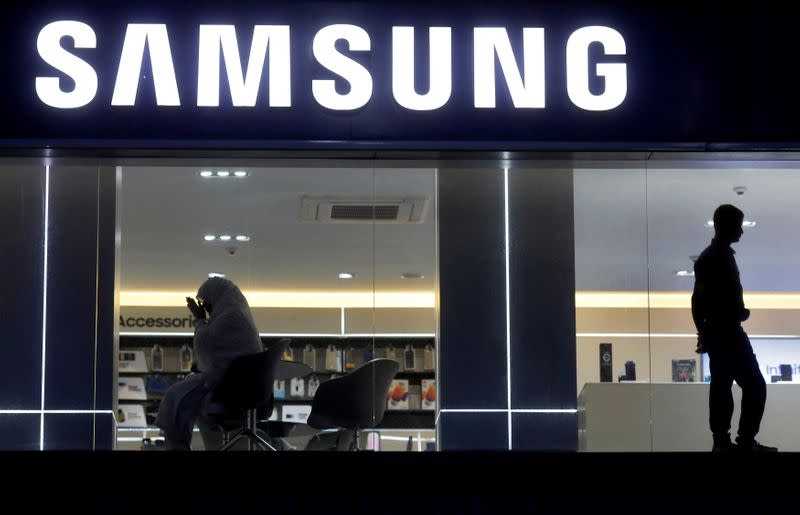 FILE PHOTO: A customer prays inside a Samsung showroom in New Delhi