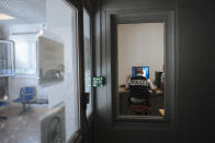 A police officer works in the police station of the Paris suburb of Sarcelles, Tuesday, June, 15, 2021. In the run-up to France's presidential elections in 2022, crime and policing are again becoming hot-button issues. Some political opponents of President Emmanuel Macron argue that France is becoming an increasingly violent country. (AP Photo/Lewis Joly)