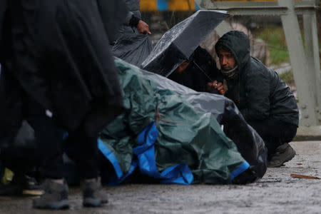 Kurdish migrants from Iran take shelter from the rain, after the dismantling of a camp in Calais, France, January 10, 2019. Picture taken January 10, 2019. REUTERS/Pascal Rossignol